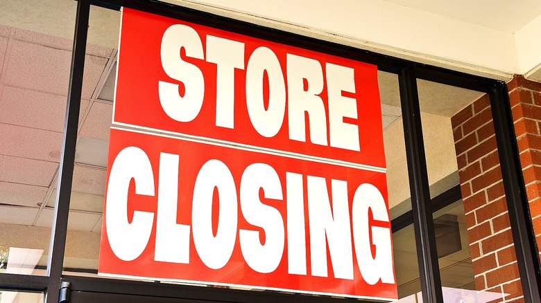 A red store closing sign