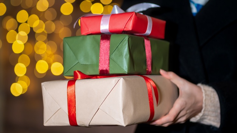 closeup of hands holding presents