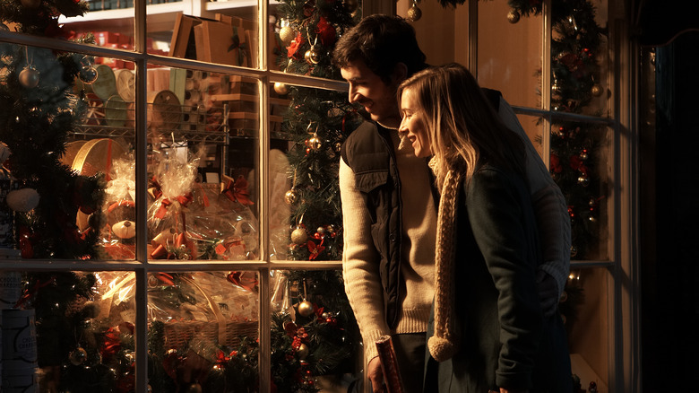 man and woman looking in shop window