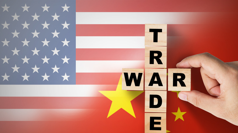 Trade war blocks overlaying American and Chinese flags