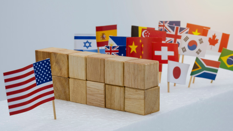 American flag separated by blocks barrier from other country flags