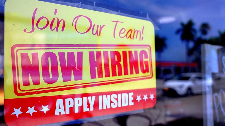 NOW HIRING sign in window