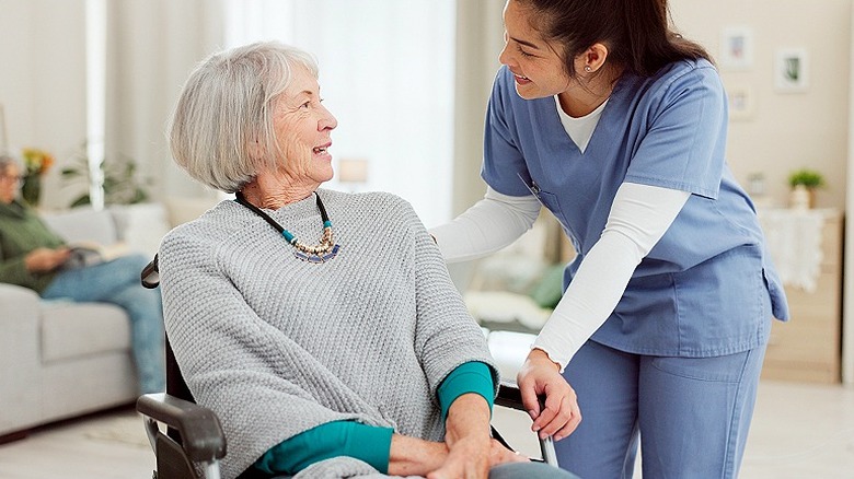 Nurse talks with an older person in a wheelchair