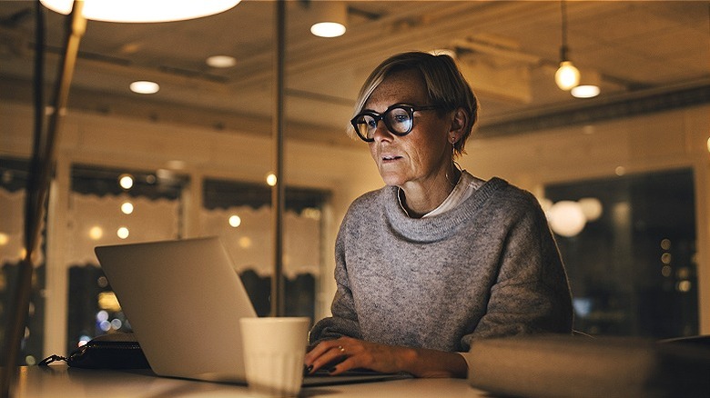 Person at laptop working late in office setting