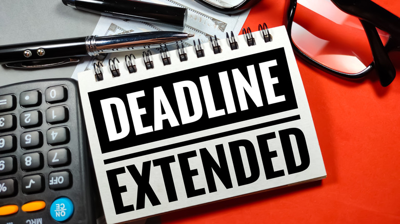 "Deadline Extended" sign with calculator