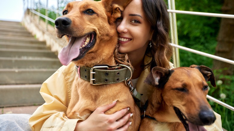 Person smiling with two dogs