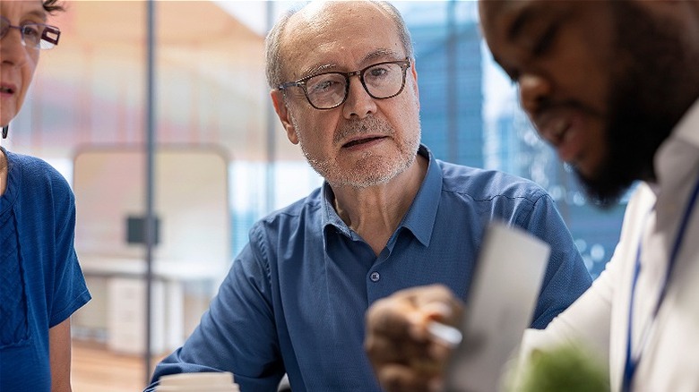 Couple listening to an adviser in an office setting