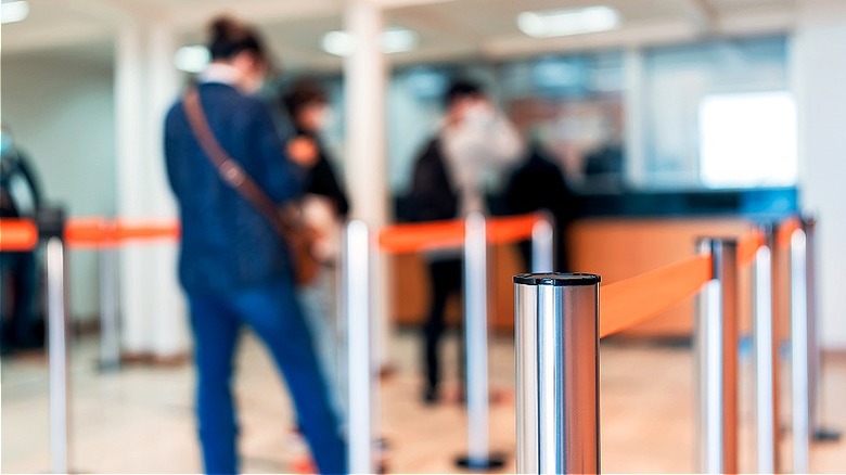 Customers waiting for bank teller