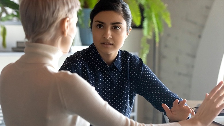 Woman in office yelling at another woman