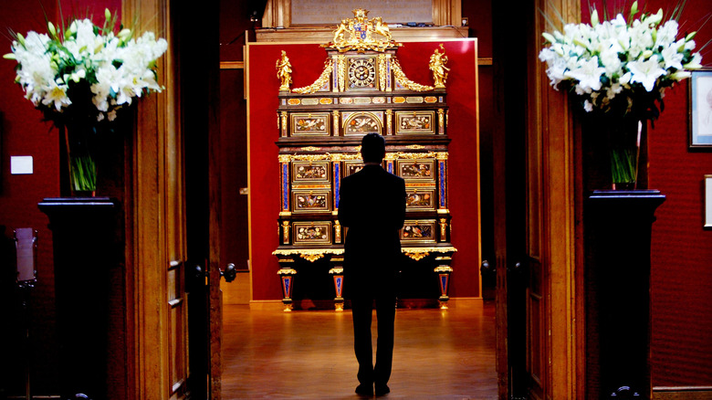 A man standing in front of the Badminton Cabinet