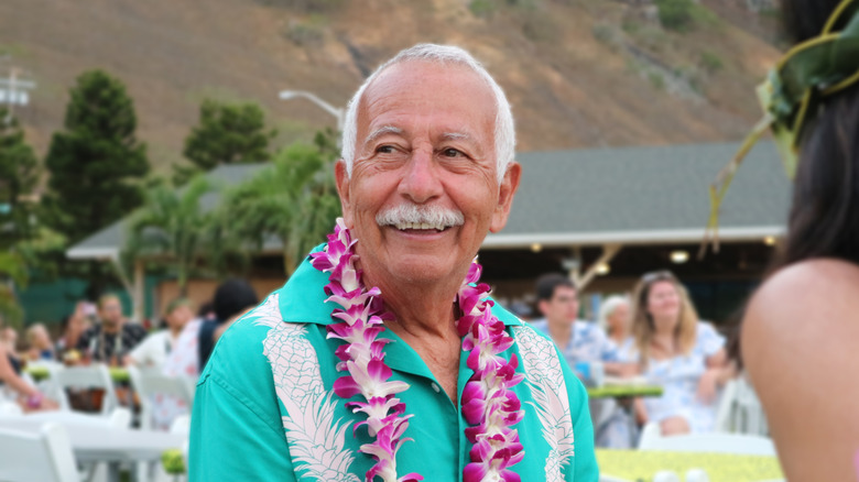 Elderly man enjoying a luau in Hawaii