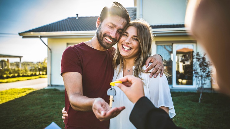 A couple grabbing house keys