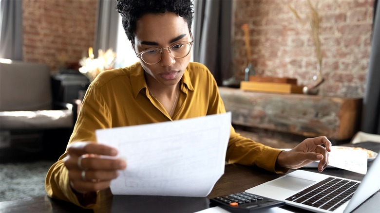 Person crunching numbers at home