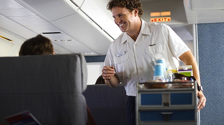 flight attendant serving passengers