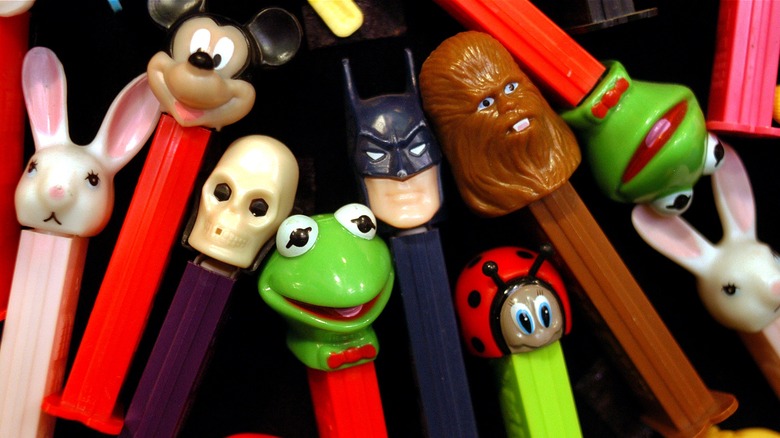 Assorted PEZ dispensers decorate surface