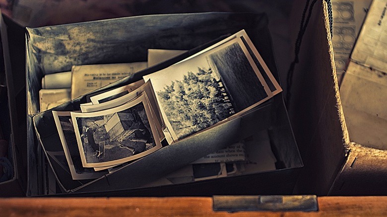 A box full of sepia-toned old photographs