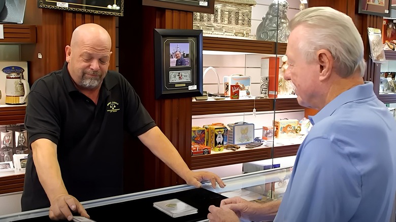 Pawn Stars cast member Rick Harrison inspecting rare coins