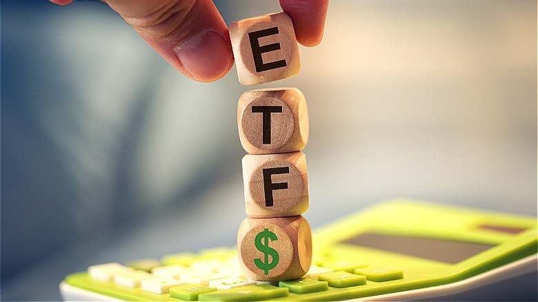 Person stacking "ETF$" blocks