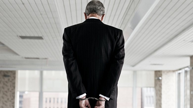 A businessman in handcuffs