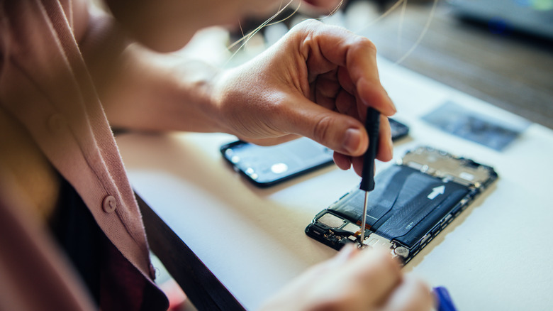 Person repairing their smartphone