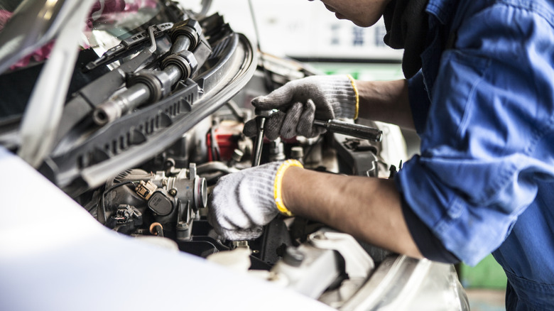 Mechanic working on car engine