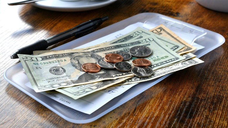 Restaurant check tray with money