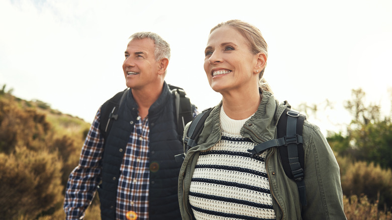 A smiling mature couple hiking