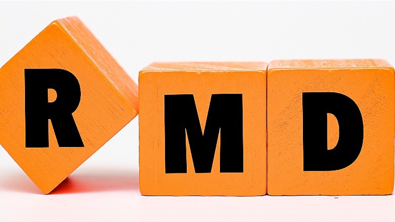 Blocks spelling out 'RMD,' with the 'R' tilted on its edge