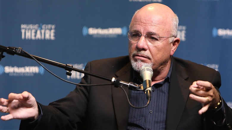 Radio personality Dave Ramsey sitting with a mic in front of him