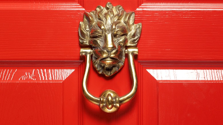 Lion door knocker, red door