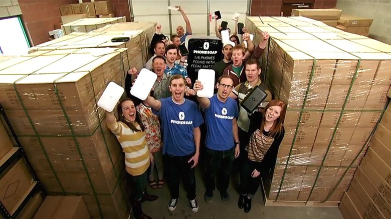 The PhoneSoap team in the warehouse cheering their product