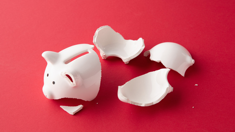 a broken pigg on red background