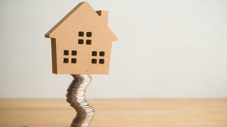 house on wobbly stack of coins