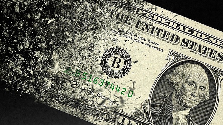 A one dollar bill disappearing 