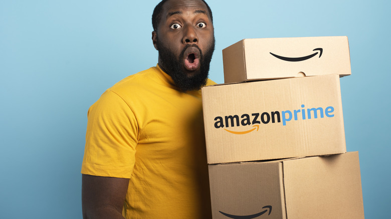man holding Amazon packages