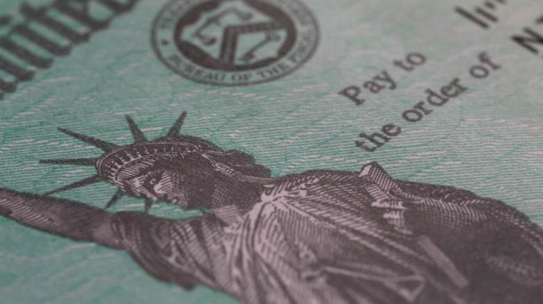 An extreme close-up of a green United States Treasury Social Security Check.