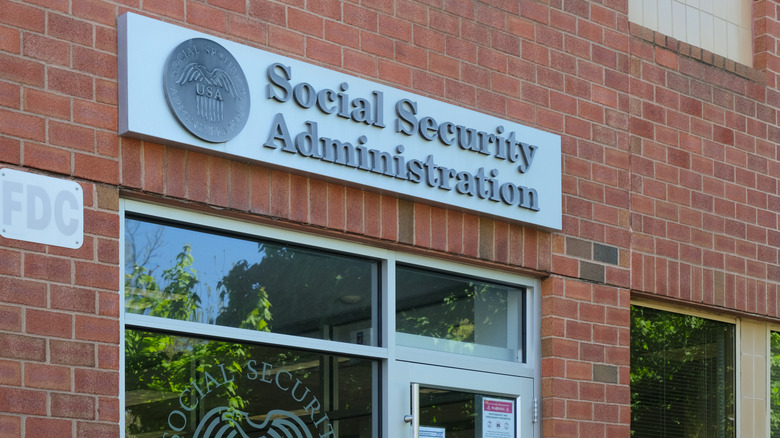 A brick-and-mortar Social Security Administration office door and sign.