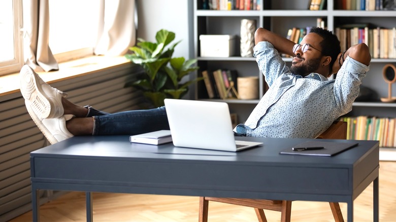 Person relaxing with laptop computer