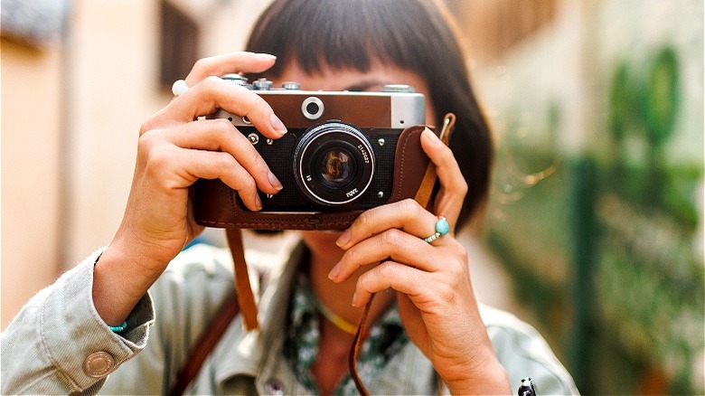 Person behind camera taking photograph