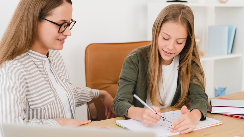 woman tutoring a young student