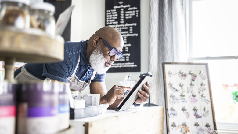 older man running a small business