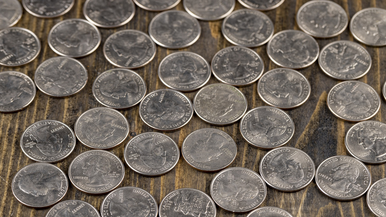 collection of quarter coins on a table