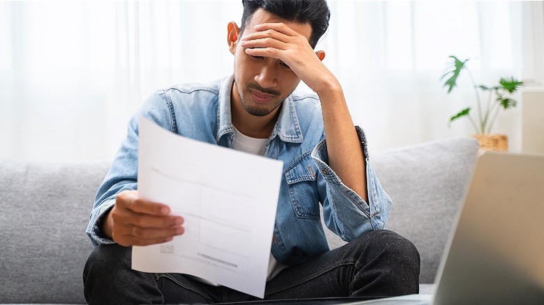 Person looking stressed over letter