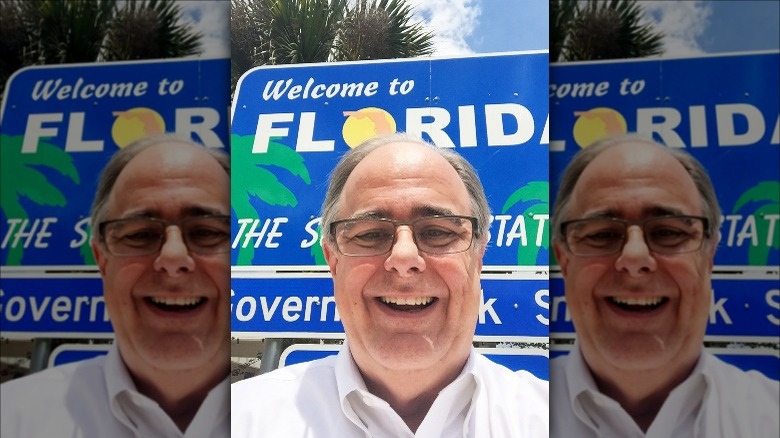 smiling man with florida sign