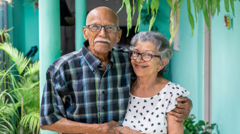 older couple with palm trees