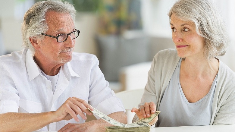 Retired couple splitting money pile