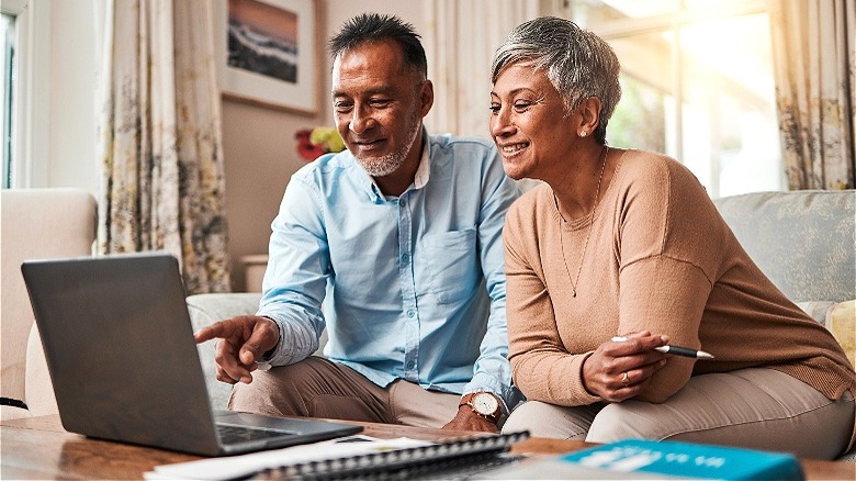 Retired couple holding cash