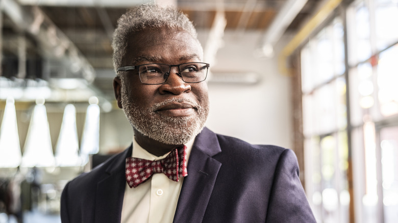 Middle-aged businessperson smiling, looking away