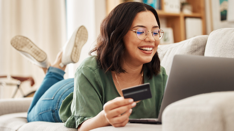 Girl on sofa with computer and website sale