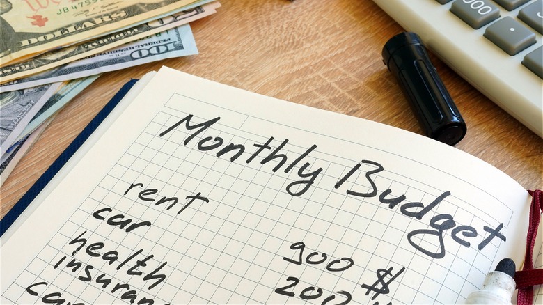 Cash with "Monthly Budget" notebook